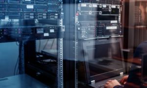 Network engineer troubleshooting in a server room.