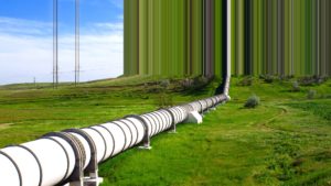 An image of a pipeline across a wide grassy field with a glitched effect
