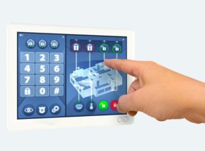 A hand touches a secure lock icon on a touchscreen home security control panel displaying a keypad and a floor plan.