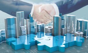 Two businesspeople shaking hands superimposed over a cityscape and large puzzle pieces, symbolizing collaboration and partnership in a corporate or urban development context.