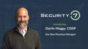 A bearded person in a sweater stands in front of a blue background with the text Security 7 Introducing... Darrin Maggy, CISSP Our New Practices Manager!.