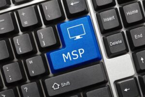 A computer keyboard with a blue key labeled "MSP" alongside an icon of a monitor, positioned among standard keys, perfect for IT MSP professionals.