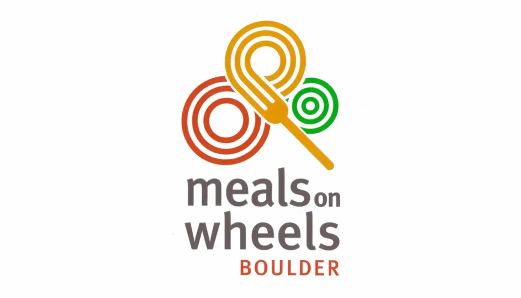 Logo of meals on wheels boulder featuring three interlinked circles in red, orange, and green, with a spoon on the left side, and the organization's name below.