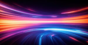 Abstract image of bright, colorful light trails in shades of orange, pink, and blue curving across a dark background, giving a sense of motion and energy.