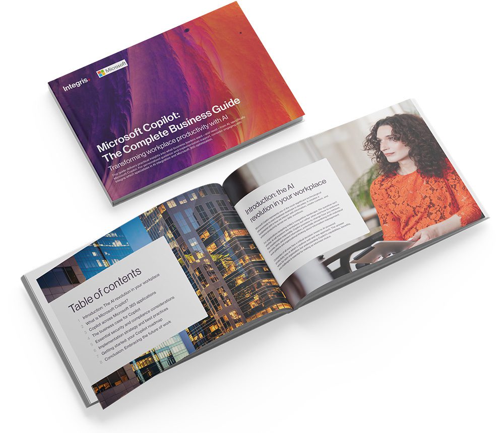 A closed and open business guide booklet titled "Microsoft Copilot: The Complete Business Guide," with the open pages showing a table of contents and a woman at a desk.