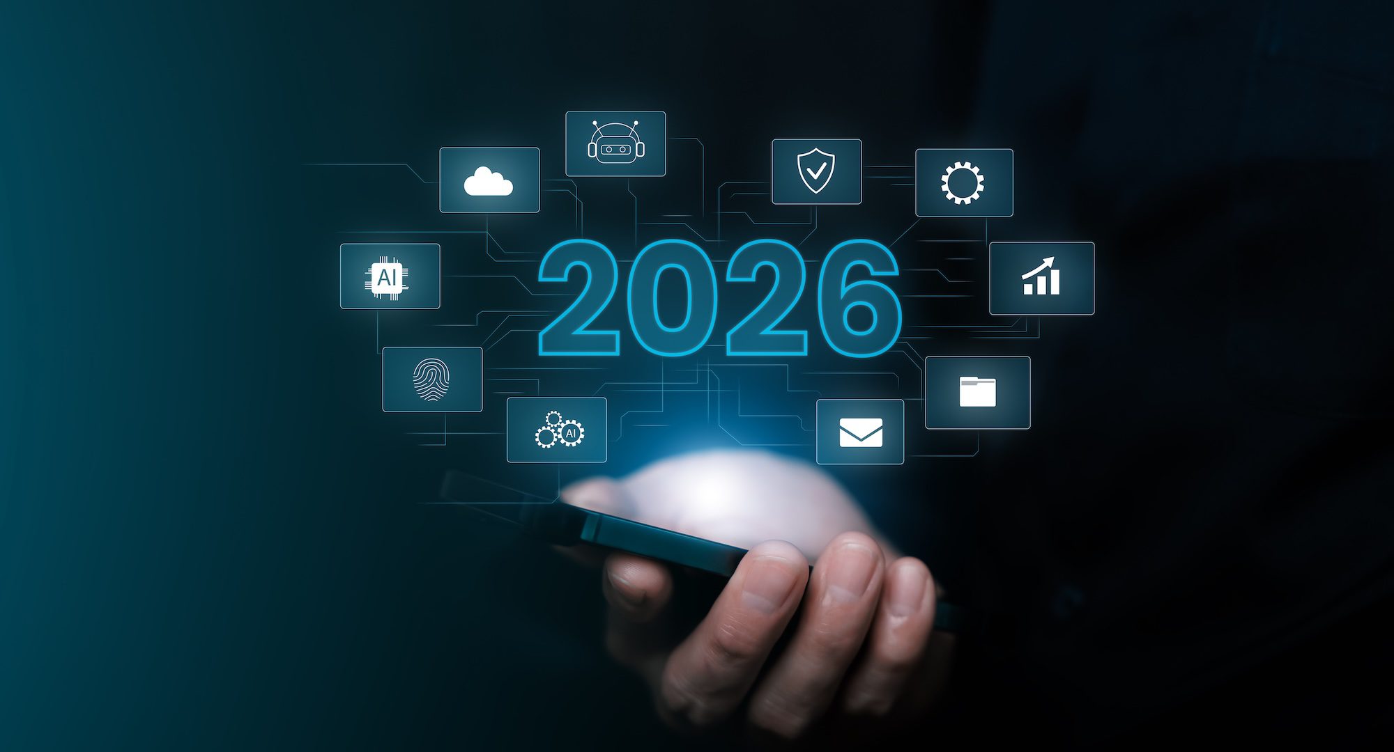 A person holds a smartphone with digital icons and the number 2026 hovering above it, symbolizing future technology and emerging MSP trends.
