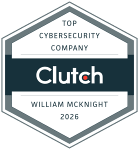 A hexagonal badge reads "Top Cybersecurity Company Clutch William McKnight 2026" in black and gray text on a white background, recognizing excellence in IT services.
