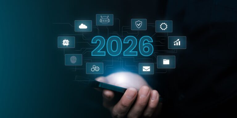 A person holds a smartphone with digital icons and the number 2026 hovering above it, symbolizing future technology and emerging MSP trends.