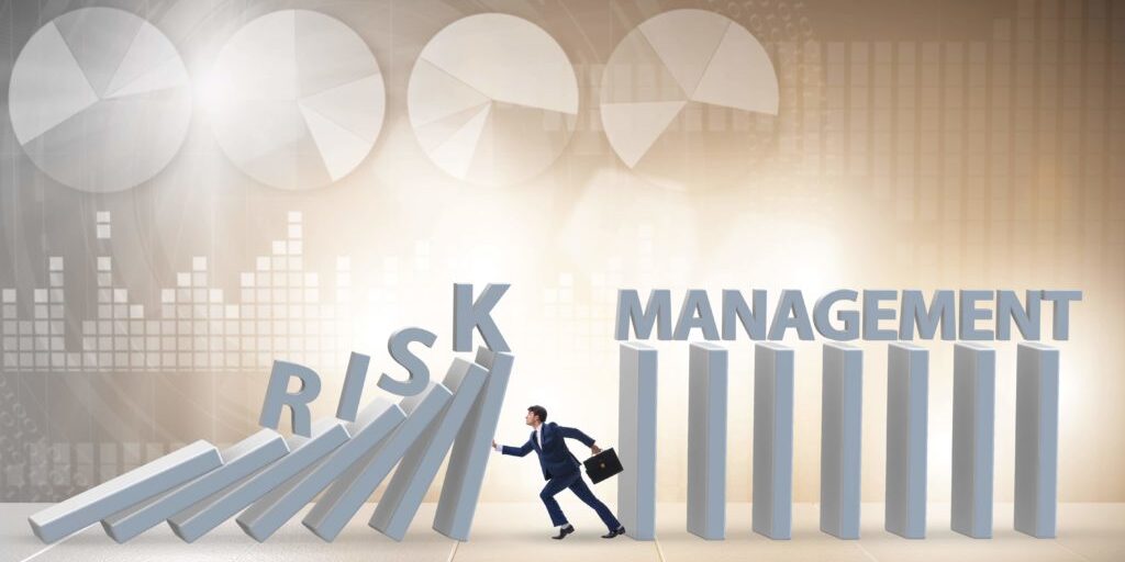 A person stops falling columns labeled "RISK" from toppling onto standing columns labeled "MANAGEMENT," representing risk management.