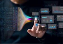 A person touches an AI icon on a virtual interface, with colorful data streams and analytic charts connected to it, symbolizing artificial intelligence, data analysis, and the emerging presence of Shadow AI.