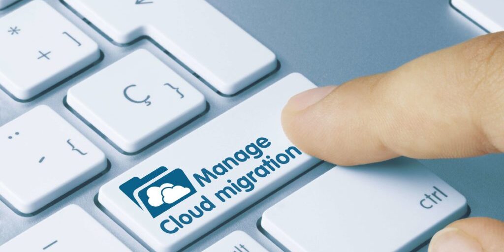 A finger presses a keyboard button labeled "Manage Cloud migration" with a cloud and folder icon, seamlessly facilitating the Microsoft Office 365 migration process.