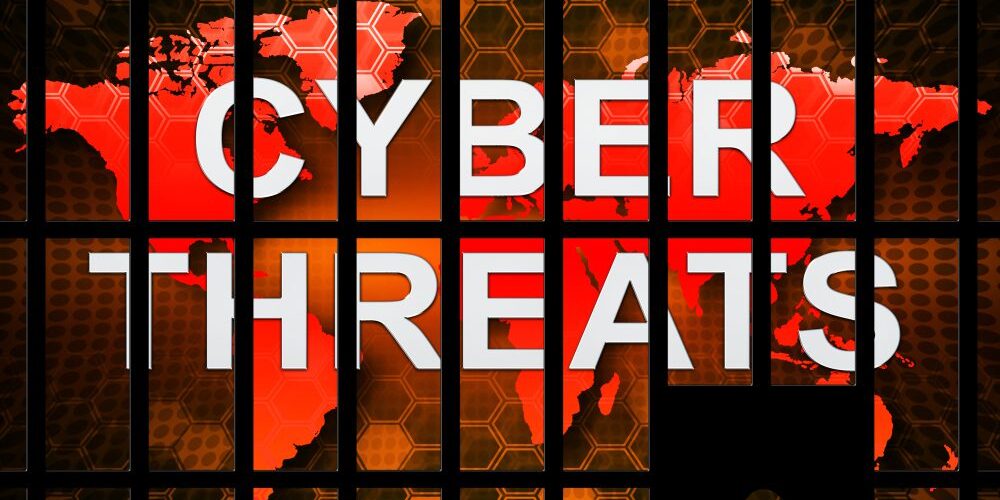 A digital graphic displaying the words "Cybersecurity Threats" over a world map, with hexagonal patterns and a padlock silhouette in the foreground.