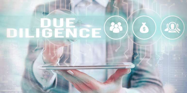 Person in a suit holding a tablet with holographic icons of people, money bag, and magnifying glass. The text "DUE DILIGENCE" is prominently displayed above the icons.