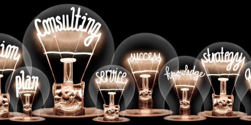 A row of light bulbs with glowing filaments, each labeled with words: solution, plan, MSP consultant, service, success, knowledge, strategy, and advice against a black background.