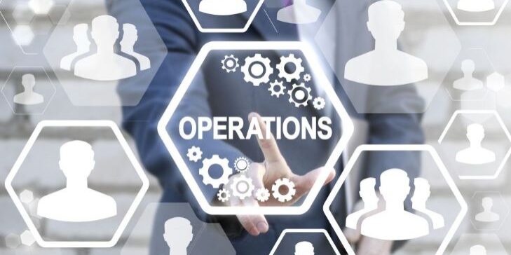 A person in a suit presses an "Operations" button on a virtual interface, seamlessly integrating peopleops, surrounded by gears and silhouettes of people.