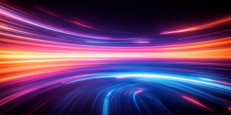 Abstract image of bright, colorful light trails in shades of orange, pink, and blue curving across a dark background, giving a sense of motion and energy.