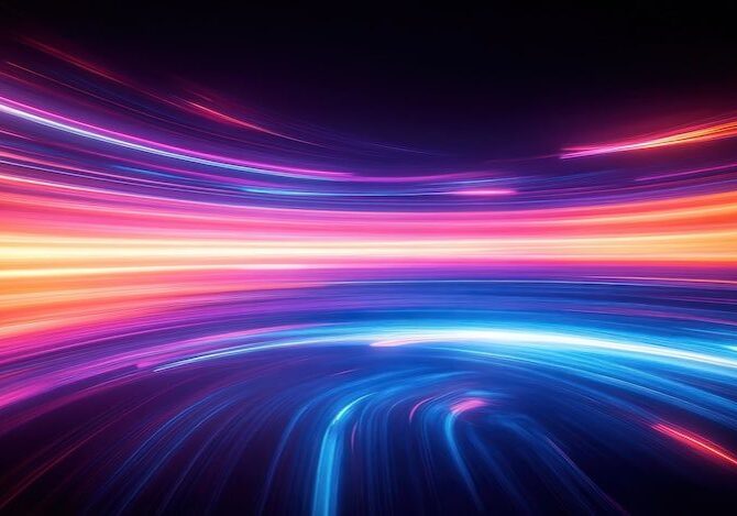Abstract image of bright, colorful light trails in shades of orange, pink, and blue curving across a dark background, giving a sense of motion and energy.