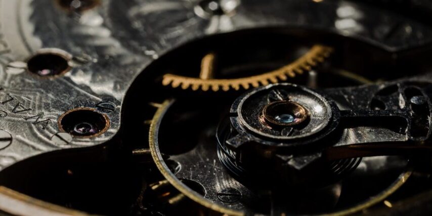 Close-up view of intricate gears and components inside a mechanical watch, resembling the complexity of IT architecture.