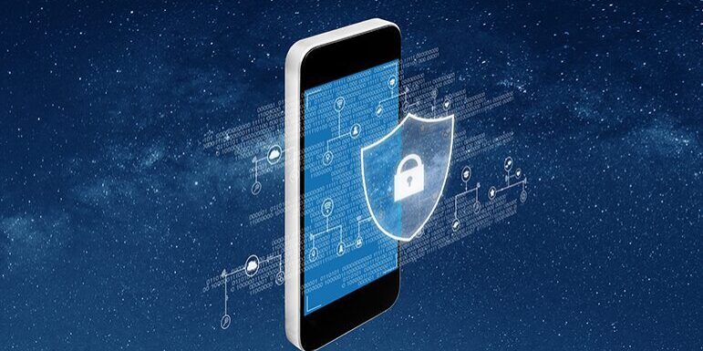 A smartphone with a holographic shield containing a padlock icon symbolizes cybersecurity. Floating binary code and digital circuits are visible in the background.
