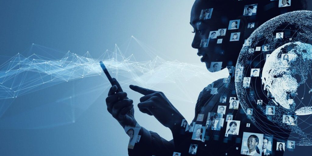 Silhouette of a person using a smartphone with multiple small profile pictures and network lines overlaid; a digital globe appears on the right side, hinting at social engineering tactics in today’s interconnected world.