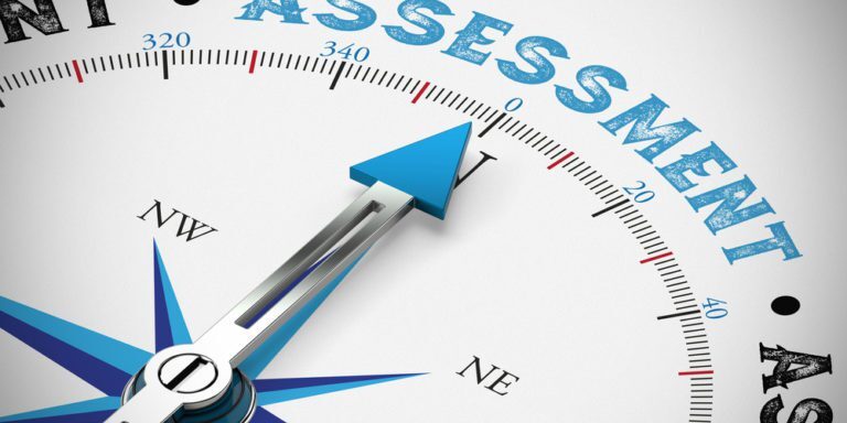 A compass pointing north toward the words "Paid IT Assessment" displayed prominently at the top center. The design includes typical compass elements like direction labels (N, E, S, W) and a blue arrow.