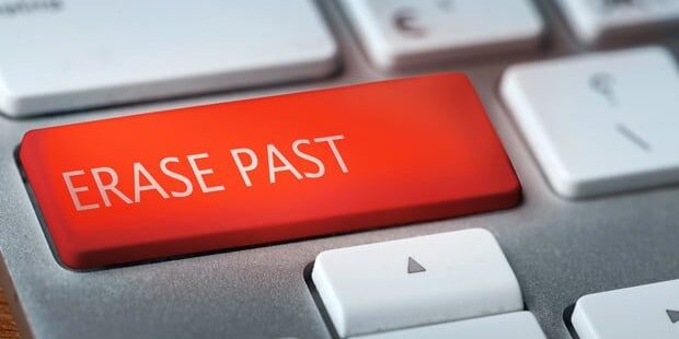 A close-up of a keyboard with a prominent red key labeled Erase Past.