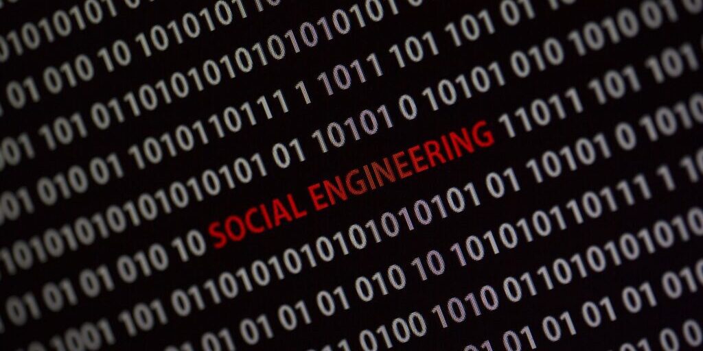 Binary code background with the words "SOCIAL ENGINEERING ATTACKS" highlighted in red.