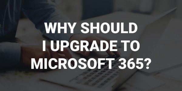 A person using a laptop with the text "WHY SHOULD I UPGRADE TO MICROSOFT 365?" displayed over the image.